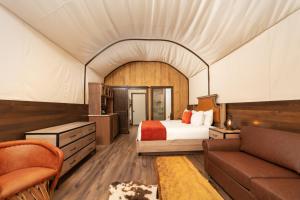 a hotel room with a bed and a couch at Westgate River Ranch Resort & Rodeo in River Ranch