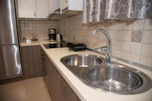 a kitchen with a sink and a refrigerator at Marabu Seaview Apartments in Nótos +75 photos
