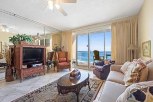 a living room with a couch and a tv and a table at Sterling Sands 708 Destin (Condo) in Destin