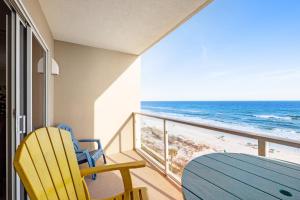 a balcony with a table and chairs and the ocean at Sterling Sands 708 Destin (Condo) in Destin