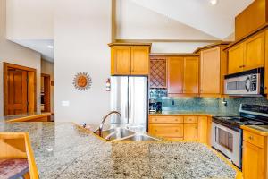 a kitchen with wooden cabinets and a sink at Spyglass 4C in Big White