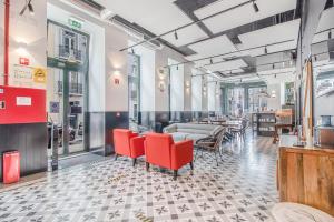 a restaurant with red chairs and tables in a room at Be Lisbon Hostel Intendente in Lisbon