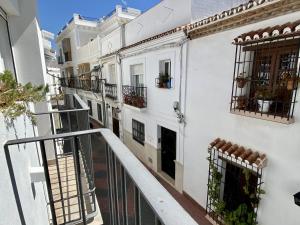 an apartment balcony with white walls and balconies at Casa Animas Casasol Centro in Nerja