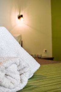 a white towel sitting on top of a bed at Panorama Hotel in Falasarna