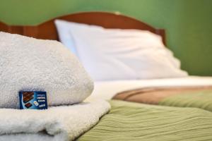 a pile of towels sitting on top of a bed at Panorama Hotel in Falasarna