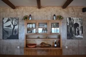 a kitchen with a wooden hutch with bottles of wine at Panorama Hotel in Falasarna