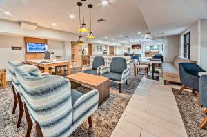 a waiting room at a hospital with chairs and tables at Staybridge Suites - Cedar Rapids North by IHG in Cedar Rapids