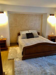 a bedroom with a large bed with two night stands at Domeniul Horj Apartament Moisei in Moisei