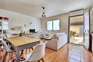 a kitchen and living room with a table and chairs at Appartement T2 Prunello By Intendance Excellency in Porto-Vecchio