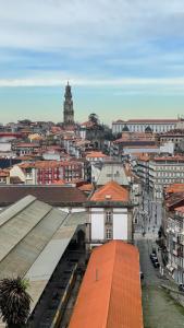 a building with a clock tower on top of it at Mystay Porto Batalha in Porto