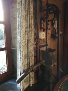 a shower in a bathroom next to a window at Gîte Le Courtil in Bouillon