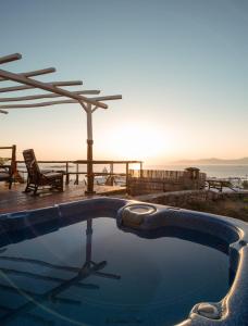 a swimming pool with a view of the ocean at Xydakis Apartments in Mýkonos City