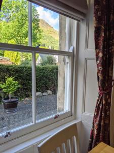 a window with a view of a mountain view at Kinloch Rannoch Holiday Cottage in Kinloch Rannoch