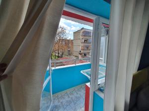 a room with a window with a view of a pool at My Apartment Polican in Poliçan