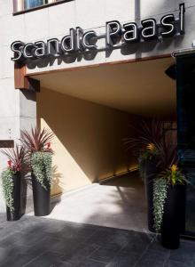 a store front with potted plants in front of it at Scandic Paasi in Helsinki