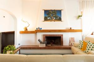 a living room with a couch and a fireplace at PURA B&b in Noicattaro