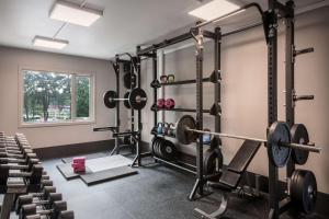 a gym with dumbbells and weights at Scandic Kokstad in Bergen
