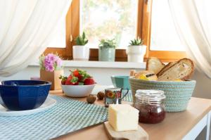 a table with bread and a bowl of cheese and other foods at PURA B&b in Noicattaro