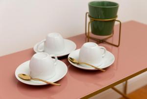 two cups and two spoons on a table at Victoria Altstadt Hotel in Düsseldorf