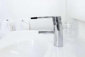 a bathroom sink with a chrome water faucet at Scandic Gardermoen in Gardermoen