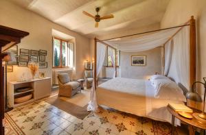 a bedroom with a bed and a ceiling fan at La Pescaia Resort in La Pescaia +44 photos
