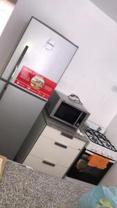 a kitchen with a stove and a counter top at Balcarce city in San Miguel de Tucumán