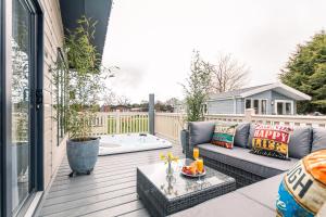 a patio with a couch and a table at Primrose Lodge with Hot Tub in York