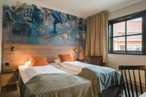 a hotel room with two beds and a painting on the wall at Scandic Hafjell in Hafjell
