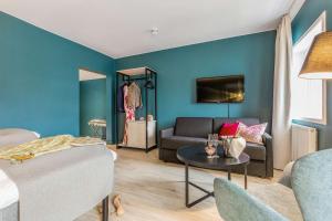 a living room with a couch and a table at Thon Partner Hotel Central in Elverum