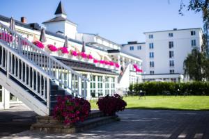 a white building with pink flowers on the stairs at Scandic Lillehammer Hotel in Lillehammer