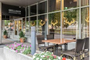 a table and chairs in front of a store at Scandic Tampere Hämeenpuisto in Tampere