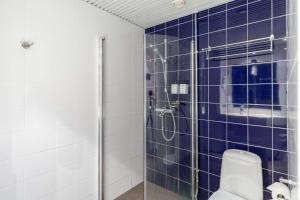 a bathroom with a shower and a toilet at Scandic Kaisaniemi in Helsinki