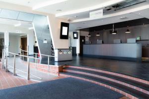 an empty lobby with a staircase in a building at Scandic Helsinki Aviapolis in Vantaa