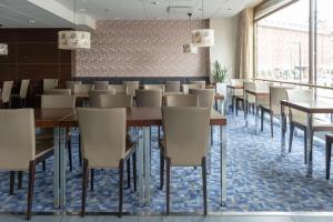 a dining room with tables and chairs at Scandic Hakaniemi in Helsinki