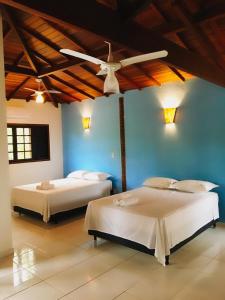 En eller flere senge i et værelse på Pousada Azul Banana - Camburi