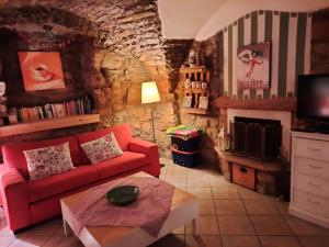 a living room with a red couch and a tv at Appartamento Sopramonte in Trento