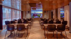 a room with rows of tables and chairs at Marski by Scandic in Helsinki