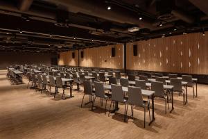 a room with rows of tables and chairs at Scandic Voss in Vossevangen