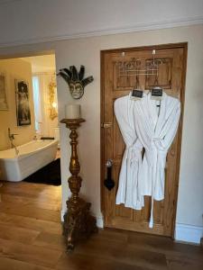 a bathroom with a door with a robe at Olivia House in Porthcawl