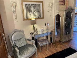 a room with a desk and a chair and a mirror at Olivia House in Porthcawl