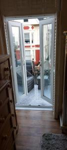 an open door to a living room with a patio at Olivia House in Porthcawl