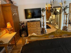 a living room with a couch and a tv at Olivia House in Porthcawl