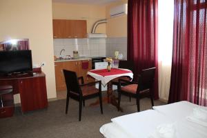 a room with a table and chairs and a kitchen at Guest House Bordo in Obzor