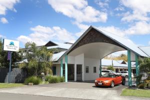 a orange car parked in front of a building at Havelock North Motor Lodge in Havelock North