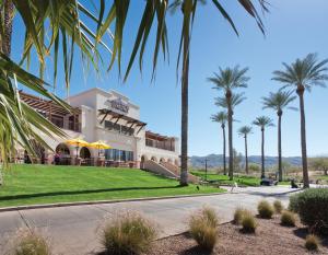 ein Gebäude mit Palmen davor in der Unterkunft The Legacy Golf Resort in Phoenix