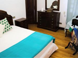 a bedroom with a bed with a dresser and a mirror at Belvilla by OYO Hacienda Lugar de Sinde in Val