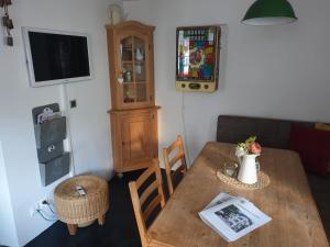 ein Wohnzimmer mit einem Holztisch und einem TV in der Unterkunft Ferienhaus Altstadt CH-Rheinfelden in Rheinfelden