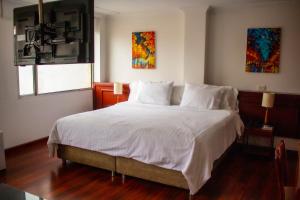 Postel nebo postele na pokoji v ubytování Hotel Sogamoso Real
