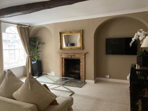 a living room with a couch and a fireplace at No.25 Steep Hill - Award Winning Street, Cathedral Quarter, Lincoln - Free Parking in Lincoln