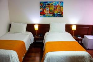 Postel nebo postele na pokoji v ubytování Hotel Sogamoso Real